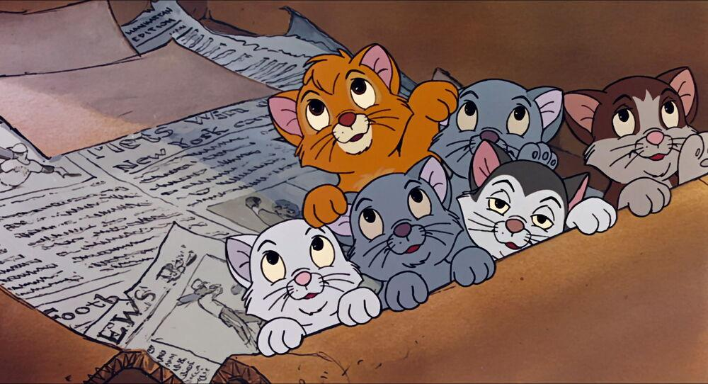 A still from Oliver & Company. A box of adorable kittens look up imploringly at passersby in hopes of being adopted.